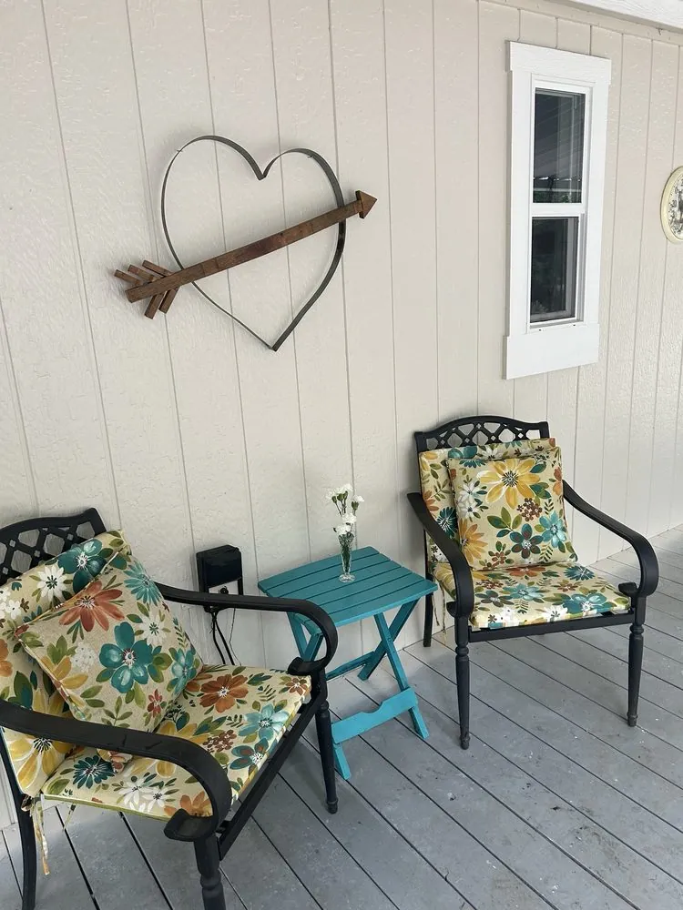 A porch wall with freshly painted siding and white window trim