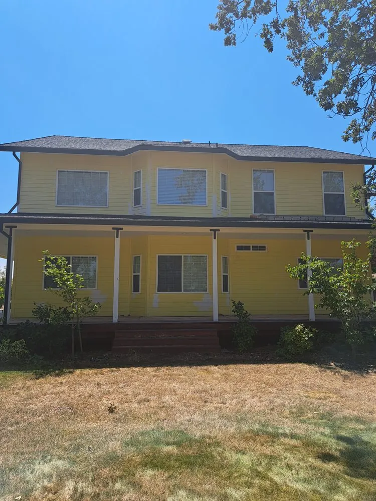 Before: the side of the yellow house, the paint worn at the porch