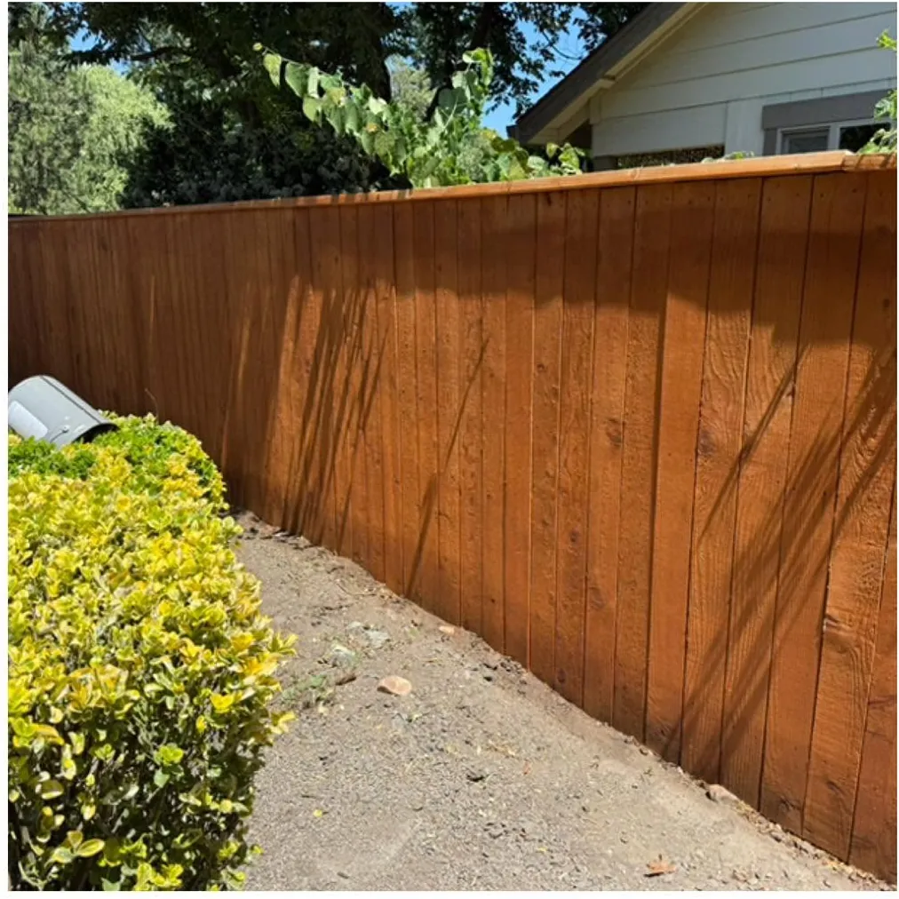 After: a long run of fence washed and sealed a warm brown