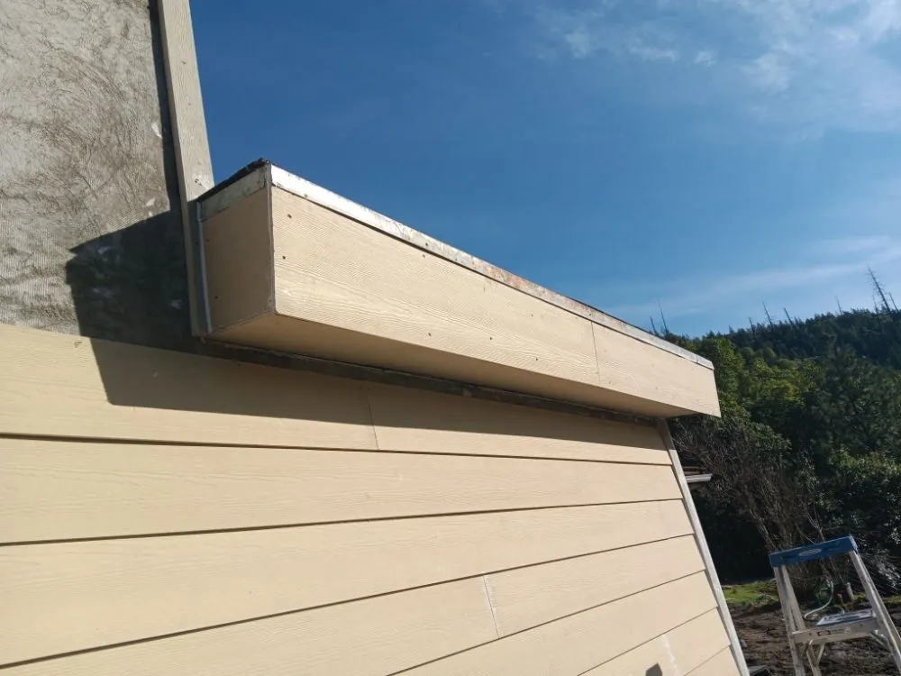 New lap siding and flashing at the roof line