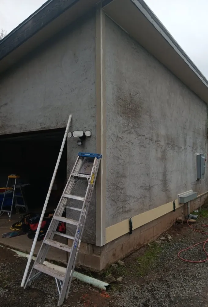 Before: a detached garage with worn stucco walls